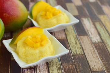 Mango pudding with cubed fresh mango on top