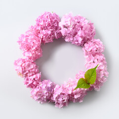Pink hydrangea flowers as wreath on grey background. View from above. Love concept. Space for text. Mother's Day Creative Greeting Card. Spring card template.