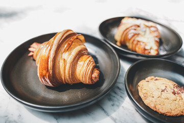 Close-Up Of Croissant Served In Black Plate , Fresh Baked Croissants. Warm Fresh Buttery Croissants and Rolls. French and American Croissants