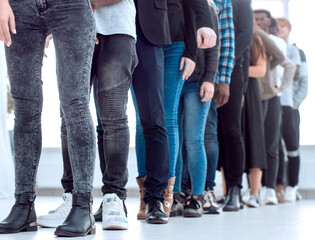 group of diverse young people standing in a queue.