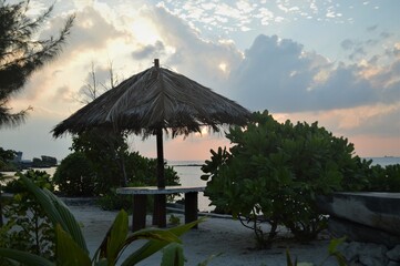 beautiful sunset view over umbrella sitting bench