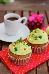 Christmas cupcake. Muffin with matcha green tea frosting, Served with espresso coffee