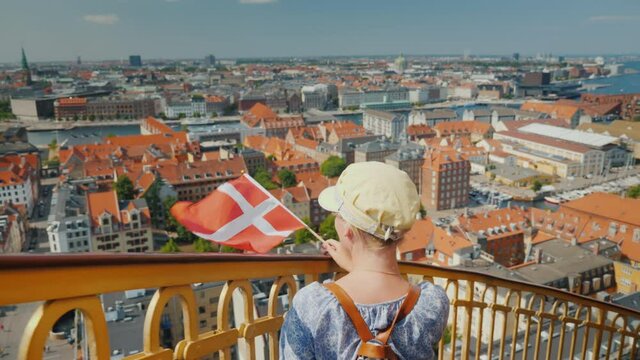 A tourist with a backpack coming down the famous spiral staircase of the Church of the Savior in Copenhagen, Denmark
