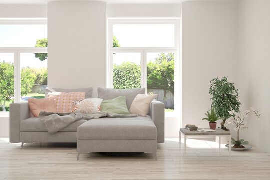 White living room with sofa and summer landscape in window. Scandinavian interior design. 3D illustration