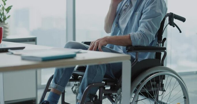Young disabled invalid male caucasian business employee tralking on mobile phone inside corporate office. Technology. Communications.