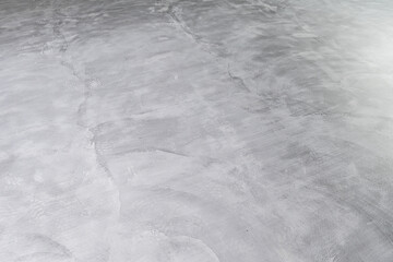 Background of Microcement grey floor with defects due to human errors
