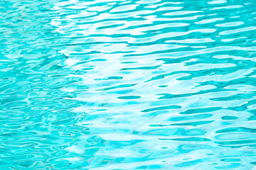 Ripple Water in swimming pool with blue tile floor background