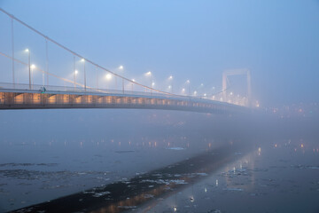 Elizabeth Bridge in mysterious fog over the icy Danube in Budapest, Hungary; color photo