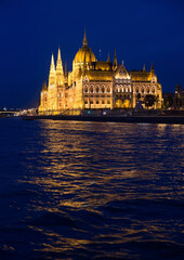 Hungarian Parliament next to the river Danube in Budapest at blue hour after sunset; color photo.