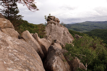 View of rocks among forest in mountains. Dovbush rocks, Ivano-Frankivsk region. ancient cave monastery in fantastic boulders amidst Carpathian mountains, Ukraine