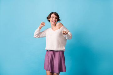 Fototapeta premium Photo portrait of gorgeous girl with closed eyes dancing isolated on pastel blue colored background