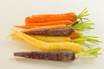 bunch of differently coloured heritage carrots, root vegetables