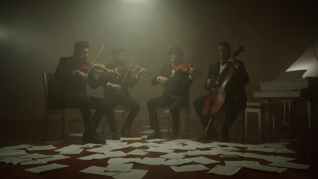 the string quartet plays classical music,notes fall from the air,