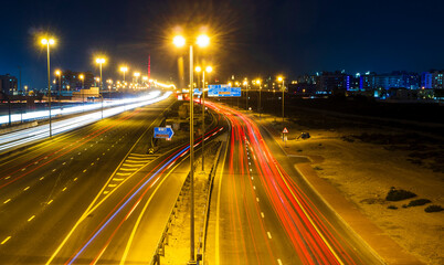 Fototapeta na wymiar Dubai, UAE - 02.22.2021 Shot of a night road with light trails. Outdoors