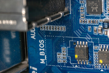 elements of the motherboard inside a personal computer covered with dust