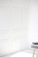 Fototapeta na wymiar White wooden wall in a room with daylight. Minimalist style. Design and interior concept. Copy space