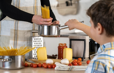 Mother and son prepearing meal at home
