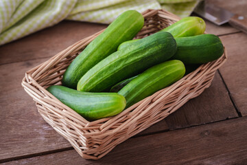 Fresh cucumber in wicker basket