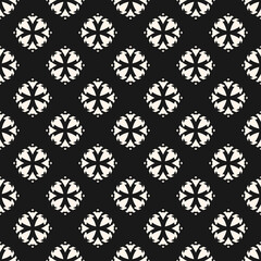 Vector ornamental seamless pattern. Black and white geometric ornament texture with small flower silhouettes, diamonds, crosses. Simple monochrome abstract floral background. Dark repeatable design 
