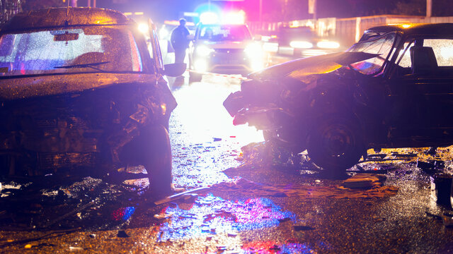Night slippy road car accident. Car crash in police light.