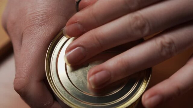Female hand opens jar with preserved green olives for cooking tasty dishes. Healthy Food, Healthy Nutrition Without GMOs, Without Glut