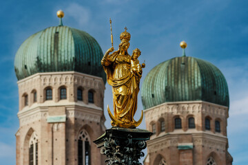 Golden Marian Column  at Marienplatz in bright sunlight in front of Marienkirchen in Munich
