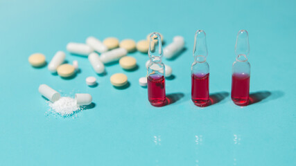 close up. ampoules and tablets on the table.