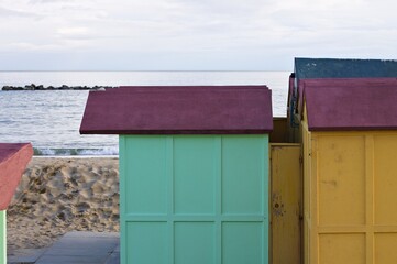Colored beach huts on the sand in front of the Mediterranean Sea on a winter day (Pesaro, Italy,...