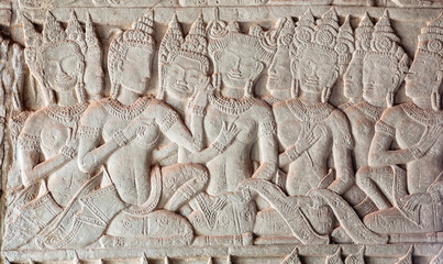 Beautiful women on historical artwork, bas-relief of Angkor What temple, 12th century Khmer landmark. Cambodian complex and UNESCO World Heritage Site