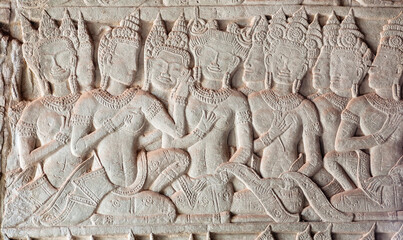 Beautiful women on historical artwork, bas-relief of Angkor What temple, 12th century Khmer landmark. Cambodian complex and UNESCO World Heritage Site