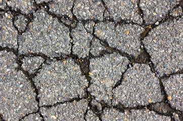 crack in the asphalt, which is made up of small colored stones 