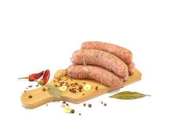 Raw pork sausages. Grilled sausages, spices close-up, isolated on a white background.Selective focus.