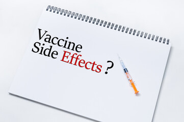 Taiping, Malaysia - circa February 2021; An isolated injection syringe on a paper notebook with words 