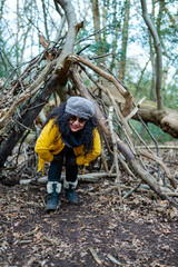 women in the woods inside a self-building refuge 