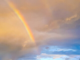 detail of rainbow arch in sunset sky and clouds 
