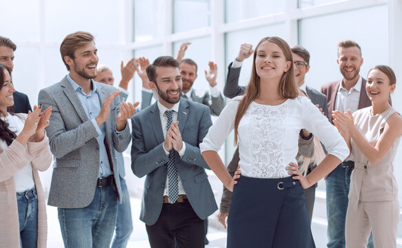 creative business team applauds a successful young colleague
