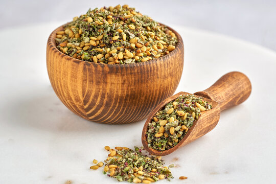 Mixed spice zaatar or zatar in wooden bowl . Closeup