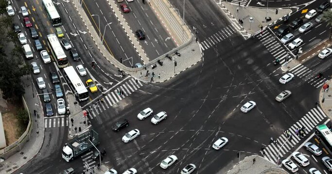 Telaviv city center streets and city traffic. Daytime top view on a cloudy day. High-speed filming. cars drive along the roads and people cross pedestrian crossings. Crossroads. 4K video