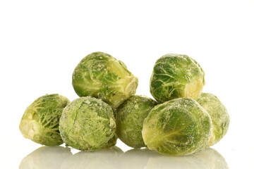 Several frozen Brussels sprouts, close-up, isolated on white.