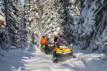 Athletes on a snowmobiles.