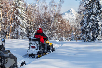 Athlete on a snowmobile.