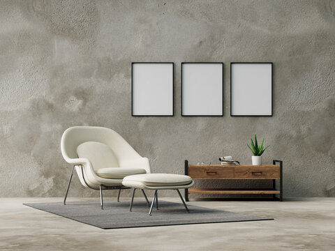 Three empty frames on wall from living room with armchair