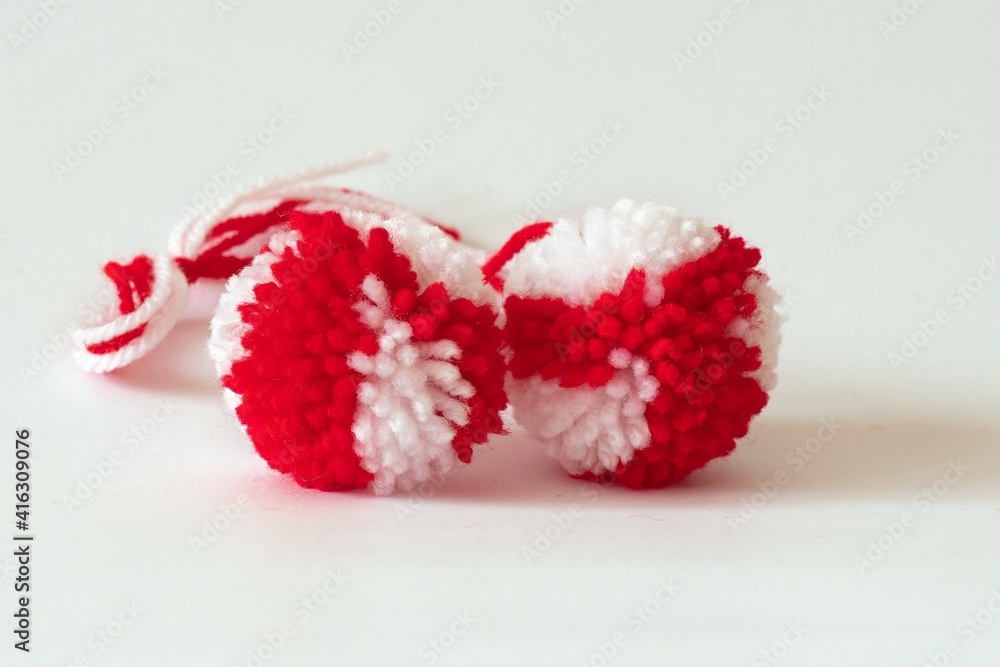 Wall mural close up red and white pompoms as martenitsa - bulgarian folklore tradition in march baba marta day.