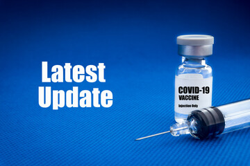 COVID-19 LATEST UPDATE text with vial on blue background. Covid-19 or Coronavirus Concept