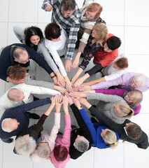 group of older people joining their palms together.