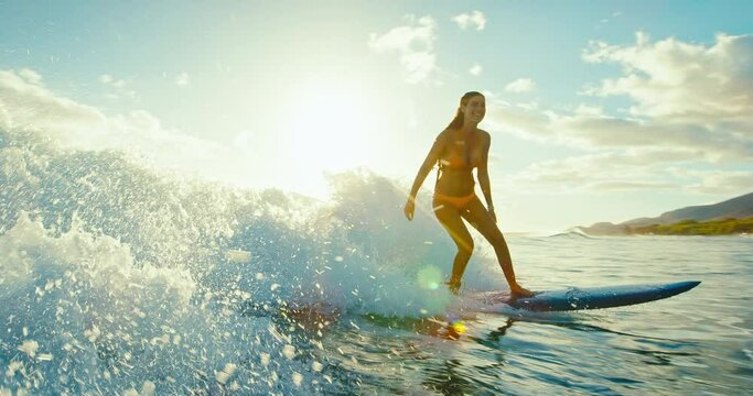 Beautiful girl surfing ocean wave at sunset, beautiful ocean wave, surf lifestyle, cinematic slow motion, shot on RED camera