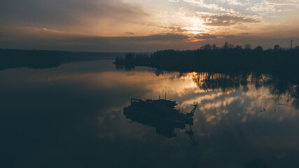 Aerial View of dredger barge extracts gravel from the bottom of a lake.