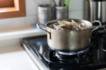 Shrimp covered with salt is being boiled in a pot.
