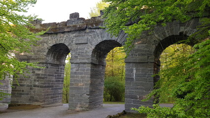 Fototapeta na wymiar An old aqueduct that looks like a stone gate, located in Kassel, Germany.