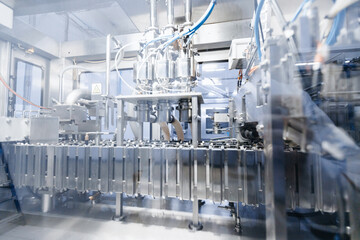 Dairy factory, plastic bags of packaged milk in automatic filling conveyor